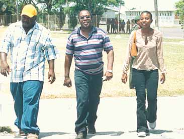 Father of the dead soldier, Lebert Todd, flanked by cousin, Roger Fortune and sister, Tracy Ann, at the GDF compound yesterday. (Pictures by Cullen Bess-Nelson)